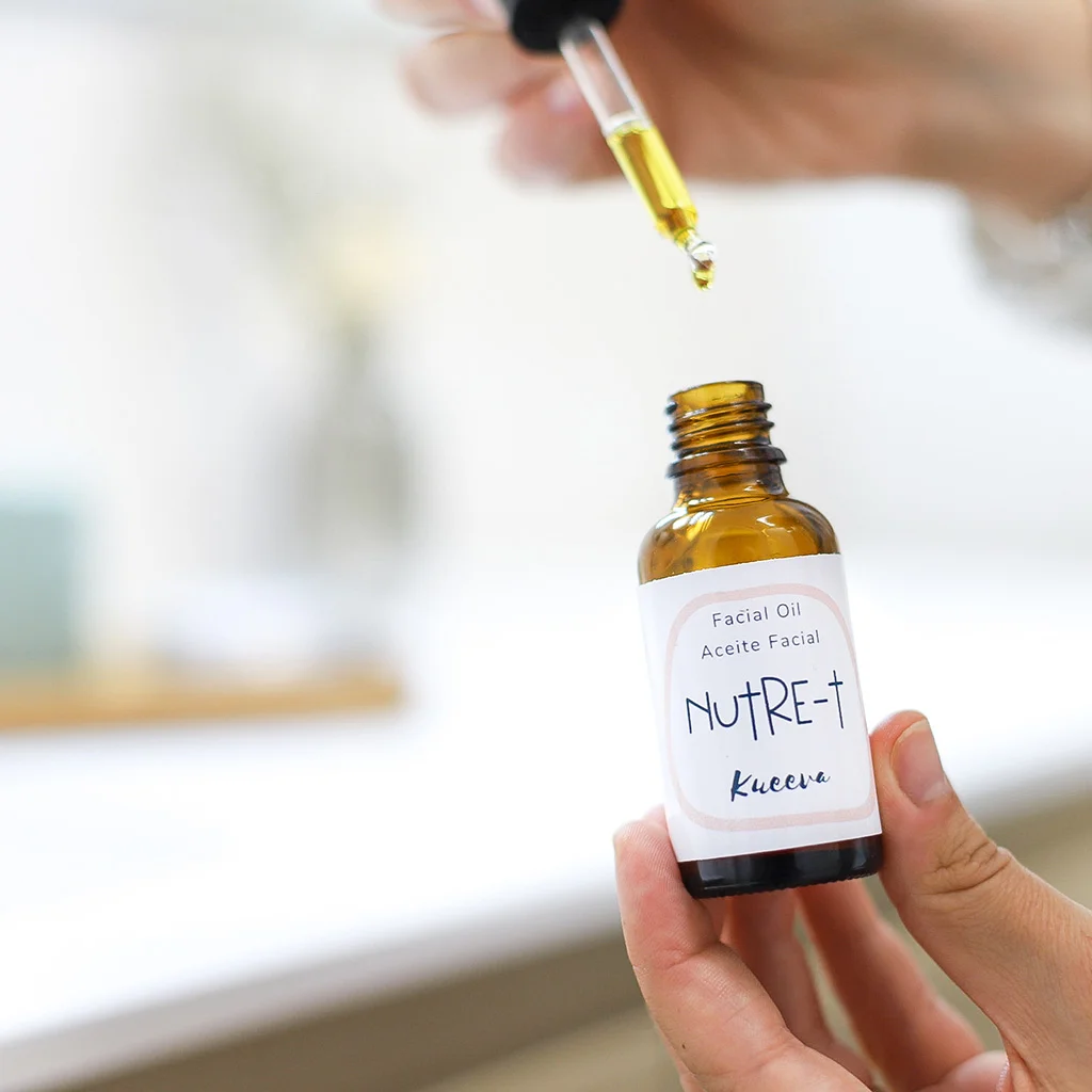 botellita de aceite facial abierta y cayendo gotas